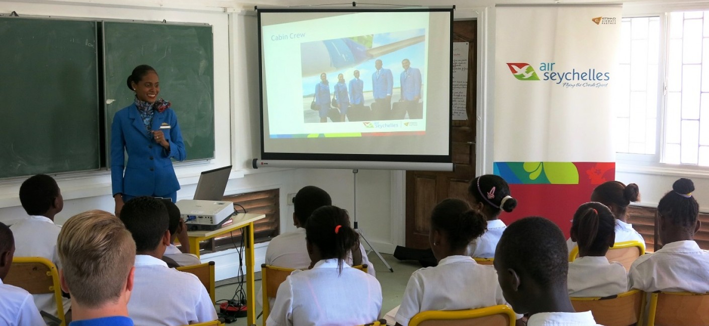 Meryl Jean explains the role of Air Seychelles Cabin Crew to children at L'Ecole Française