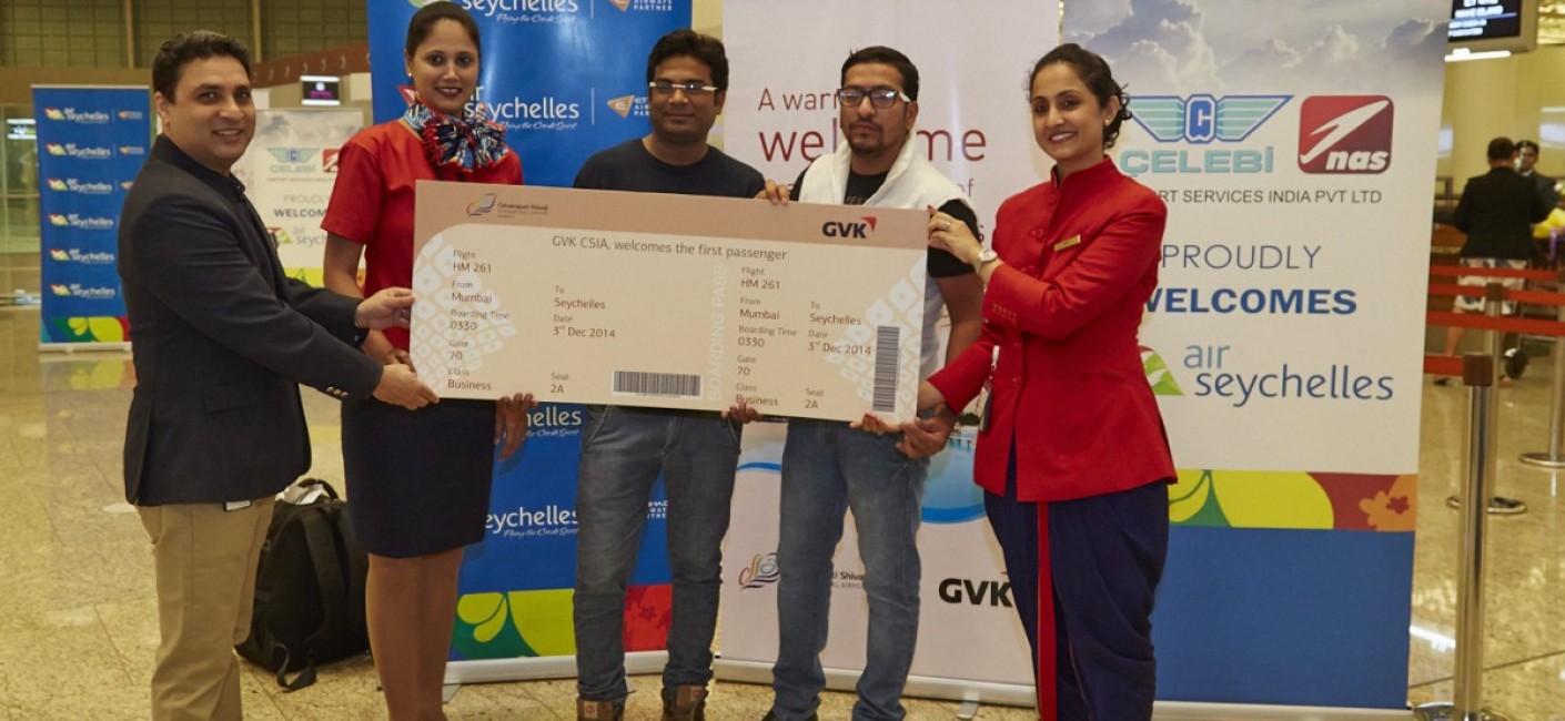Naveen Chawla, Vice President Aero Marketing at GVK, one of India's largest private sector airport operators, presents the first commercial passengers flying Mumbai – Mahé with a commemorative ticket