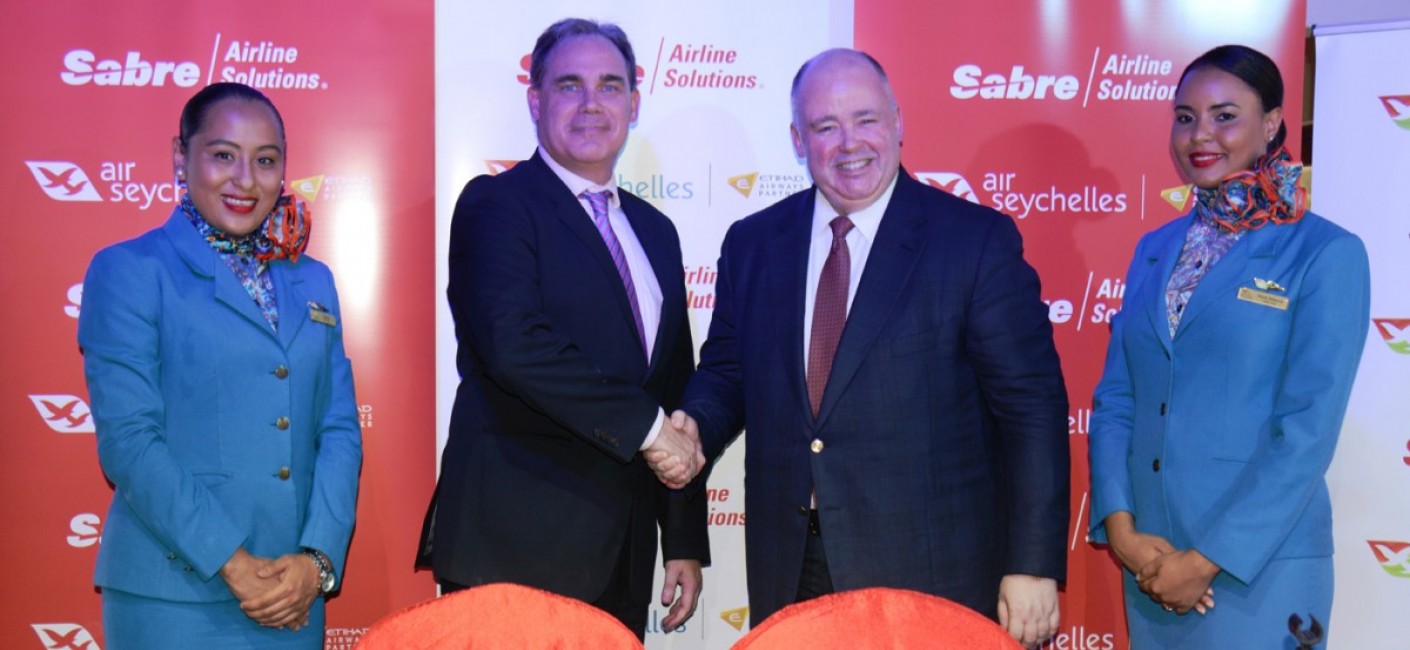 Roy Kinnear, Chief Executive Officer of Air Seychelles, shakes hands with Shane Batt, Senior Vice President, Strategic Clients, Sabre
