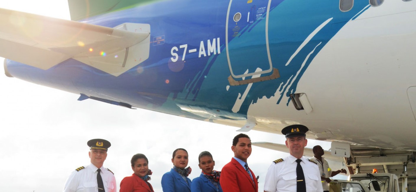 Air Seychelles pilots and cabin crew stand proudly in front of the airline’s first Airbus aircraft to be registered in Seychelles, an Airbus A320 with registration number S7-AMI