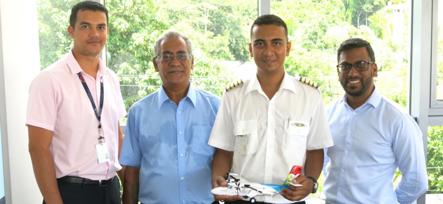 Allen Dubignon (first left), Chief Pilot Domestic, Purdy Quatre (second left), Administrator Ground Services Equipment and father of Captain Aubrey Quatre and Manoj Papa (right), Air Seychelles’ Chief Executive Officer, congratulate the young pilot on his achievement.