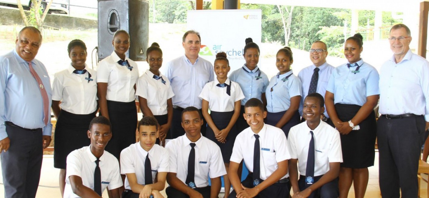 John Stravens, Chairperson of STA (first left), Roy Kinnear, Chief Executive Officer of Air Seychelles (fifth from left), Flavien Joubert, Principal of STA (third from right) and Peter Carrie-Wilson, General Manager Human Resources at Air Seychelles (first from right), stand next to current students at the STA